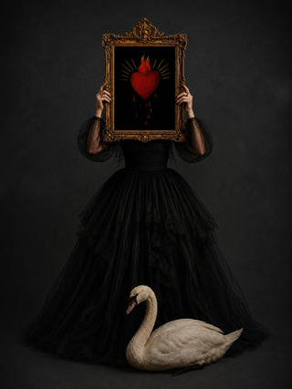 Loren Estes wearing a black tulle gown with a swan by her feet holding her work bleeding heart on a black canvas with baroque frame