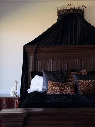 Loren Estes collection of pillows Relic, Sable and Muse on a bad with a velvet duvet.